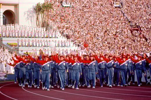 Members of the US Olympics Team wave to spectators as they march into the LA Coliseum during the opening ceremonies for the 1984 Summer Olympics, National Archives Identifier, 6386474 