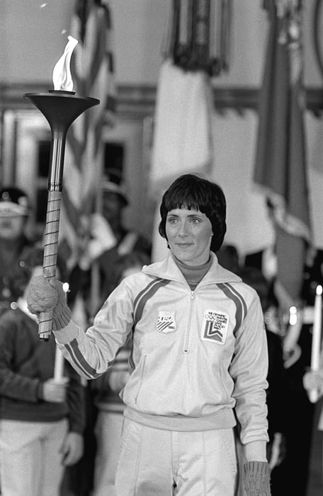 Black and white photograph of Sandy Norris carrying the Olympic torch
