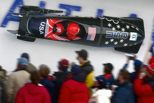 Bobsled race as seen from above. Spectators look on