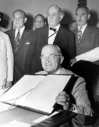man signing North Atlantic Treaty document