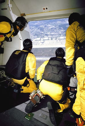 Member of the US Army (USA) Parachute Demonstration Team, The Golden Knights, gaze out the door of their aircraft before jumping during the Armed Forces Day Joint-Service Open House, held at Andrews Air Force (AFB), Maryland (MD), 1991