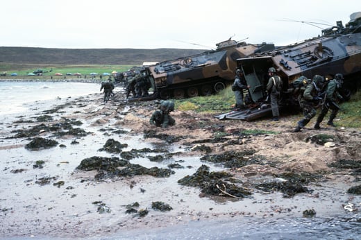Combat-ready Marines of the 4th Marine Amphibious Brigade charge out of LVTP-7 tracked landing vehicles on Red Beach during the NATO exercise Northern Wedding