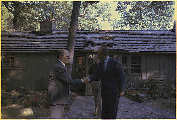 Menachem Begin and Anwar Sadat greet each other at Camp David., National Archives Identifier 181109