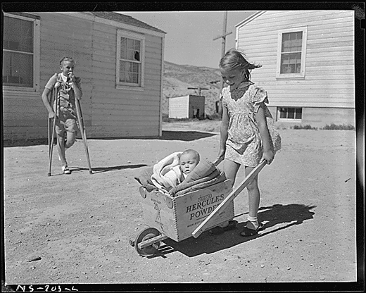 Children of miner living in company housing project. Note the homemade baby buggy made of a powder box. Union Pacific Coal Company, Reliance Mine, Reliance, Sweetwater County, Wyoming. National Archives Identifier 540560