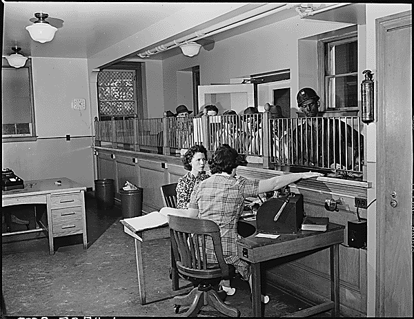 Credit department of the company. Miners are pictured drawing money in advance of payday. Inland Steel Company, Wheelwright #1 & 2 Mines, Wheelwright, Floyd County, Kentucky. National Archives Identifier 541493