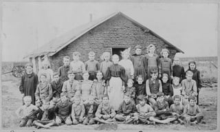 Teacher and Children in Front of Schoolhouse, ca. 1895