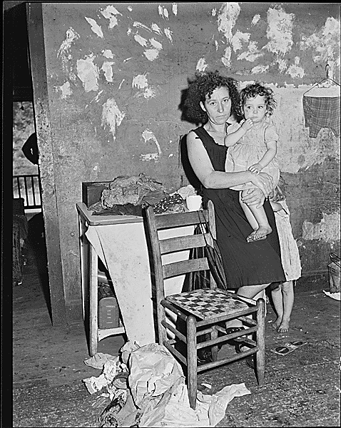 Mrs. Elige Hicks and her daughter in the kitchen of the four room house which rents for $10.50 monthly. Mrs. Hicks' husband and son are now working in a coal mine in Virginia and are looking for a home to buy. Southern Coal Corporation, Bradshaw Mine, Bradshaw, McDowell County, West Virginia. National Archives Identifier 541034